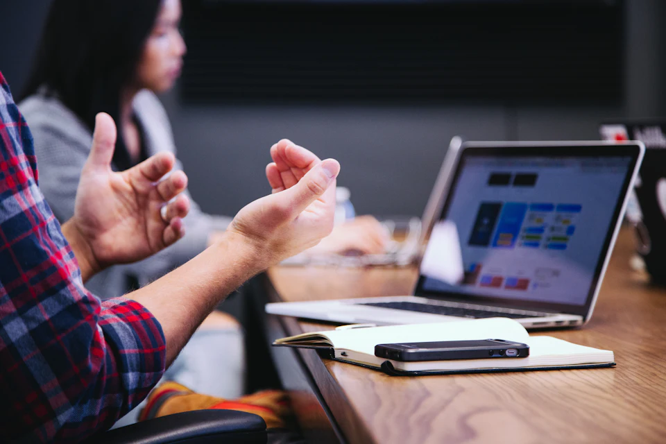 Advisors discussing figures over a laptop