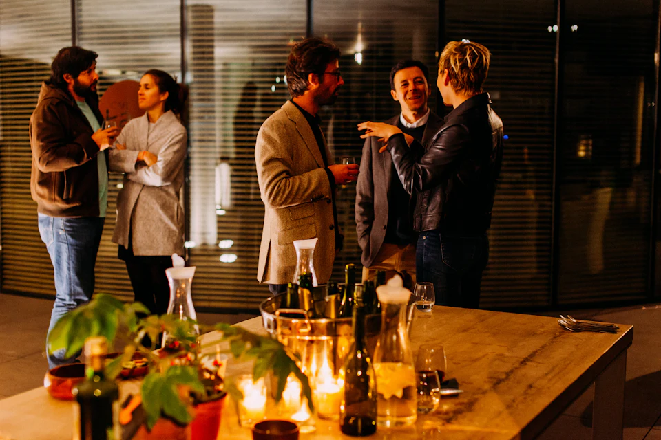 Professionals in conversation at an evening meeting