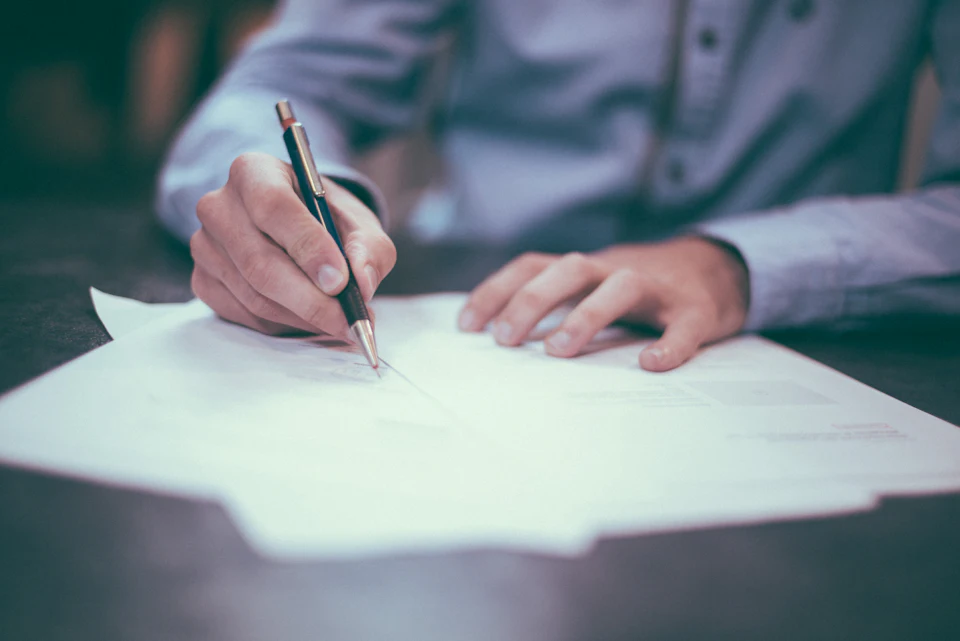 An advisor signing documents